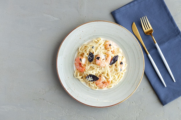 Seafood pasta with shrimps and cream sauce served on plate