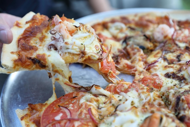 Seafood pizza , with mussel squid shrimp and tomato , italian food