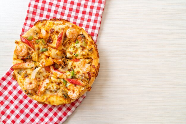 seafood pizza on wood tray