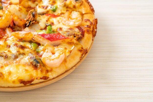 seafood pizza on wood tray