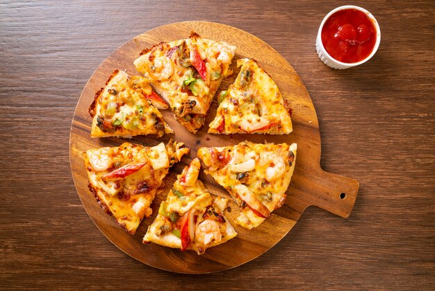 seafood pizza on wood tray