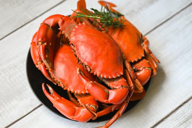 Seafood plate with herbs spices rosemary fresh crab on black plate crab cooking food boiled or steamed crab red in the restaurant