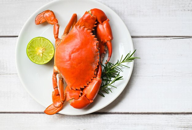seafood plate with herbs spices rosemary lemon lime fresh crab on white plate crab cooking food boiled or steamed crab red in the restaurant