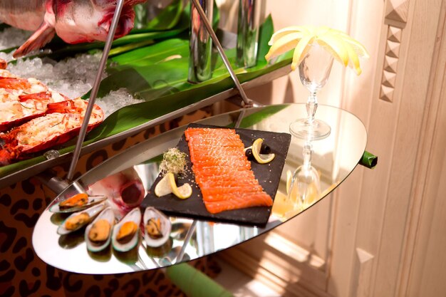 Seafood platter and oysters on mirrored table