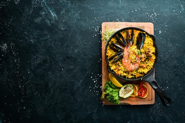 Photo seafood rice. paella with mussels and shrimp. top view. free space for your text.