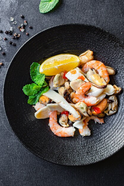 Seafood salad assortment on a black plate