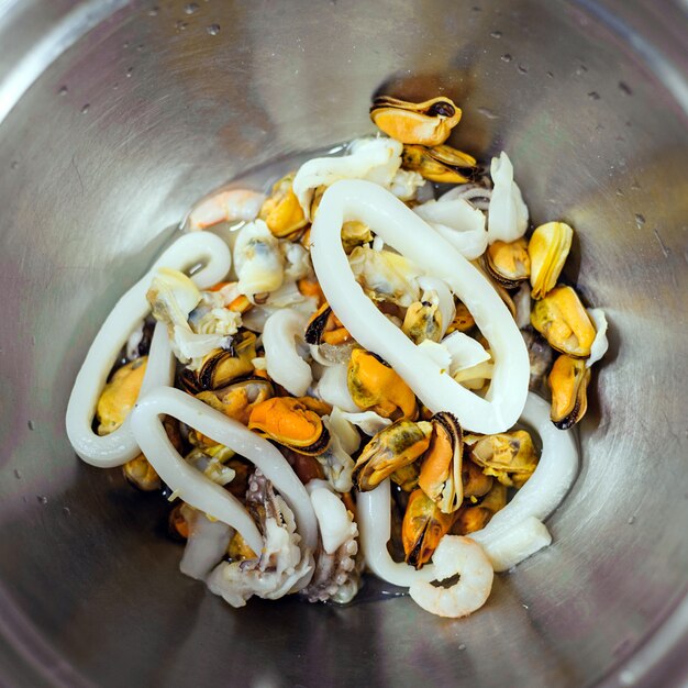 A seafood Salad in metal bowl, top view