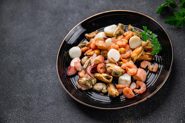 seafood salad shrimp, mussel, scallop, octopus healthy meal food snack on the table copy space