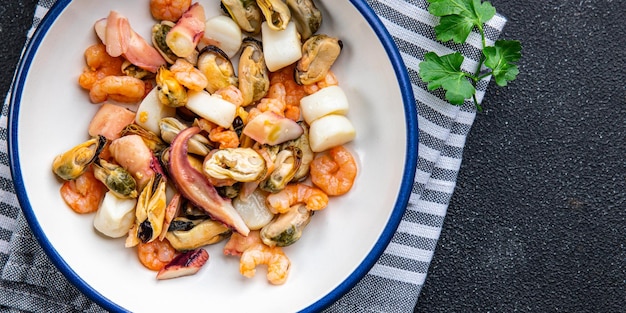 seafood salad shrimp, mussel, scallop, octopus healthy meal food snack on the table copy space