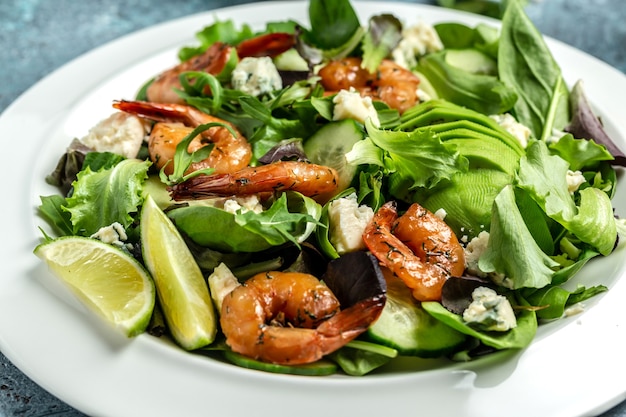 Seafood salad with avocado, blue cheese and smoked shrimps. Healthy food. Clean eating. Food recipe background. Close up.