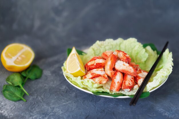 Seafood salad with crab meat and fresh romaine lettuce leaves and lemon