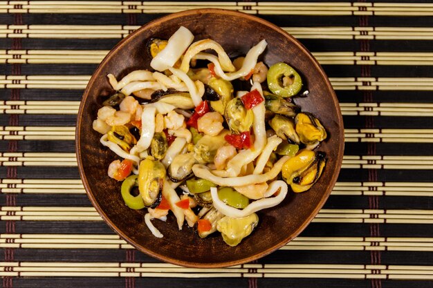 Seafood salad with shrimp squid and mussels on bamboo mat