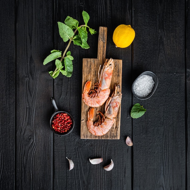 Seafood scampi on wooden board over black wood table