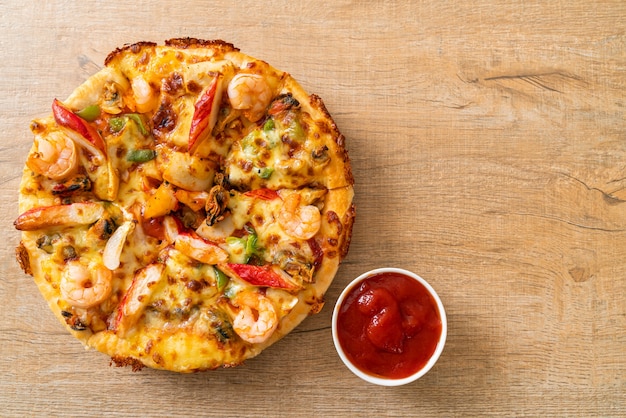 Seafood (shrimps, octopus, mussel and crab) pizza on wood tray