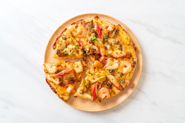 seafood (shrimps, octopus, mussel and crab) pizza on wood tray