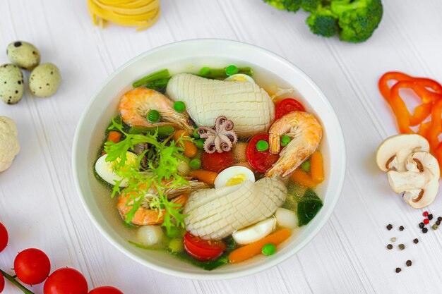 Photo seafood soup with squid shrimp and boiled egg diet food