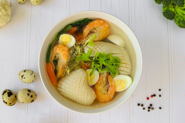 Seafood soup with squid shrimp and boiled egg diet food