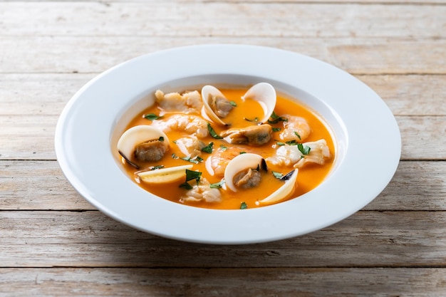 Seafood soup on wooden table