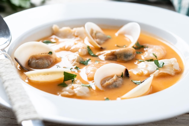 Photo seafood soup on wooden table