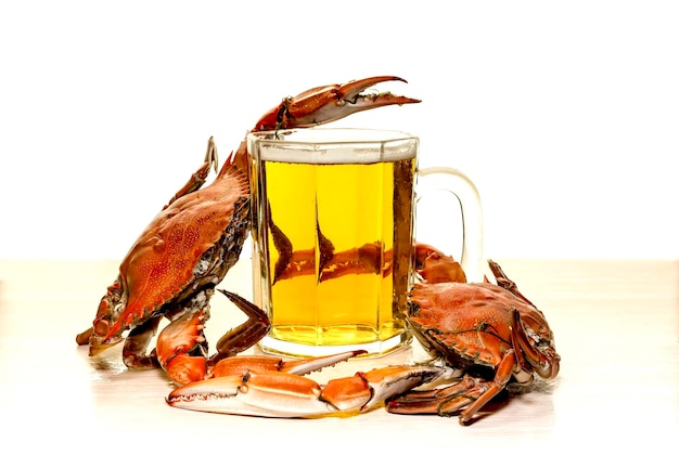 Seafood Tasty fresh boiled crabs and beer in a mug closeup on a white background