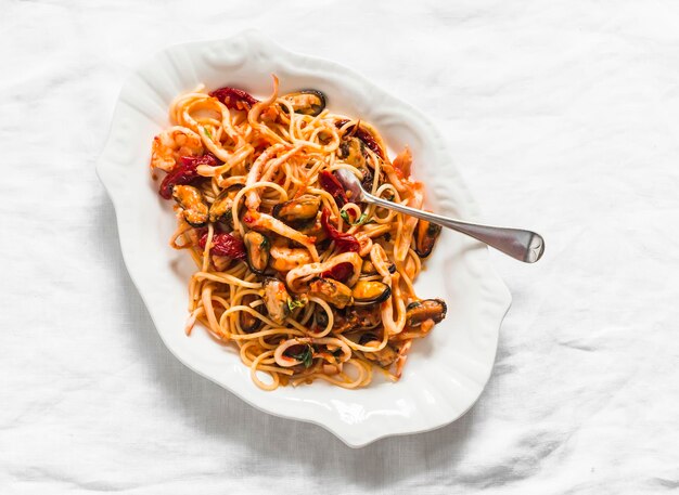 Seafood tomato sauce pasta delicious lunch dinner on a light background top view