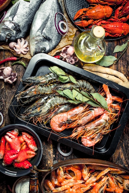 Seafood with spices on a wooden table.