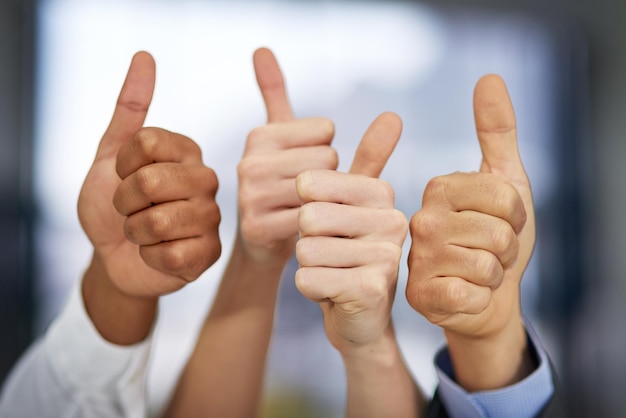 The seal of approval Shot of a group of unrecognizable businesspeople pulling thumbs up