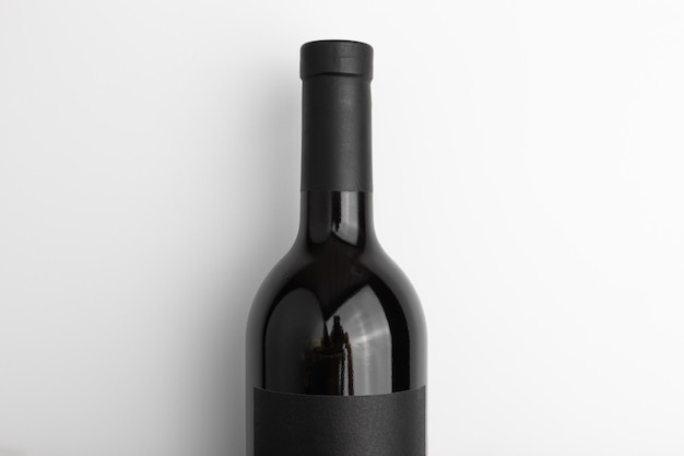 Sealed red wine in a dark bottle with blank black label