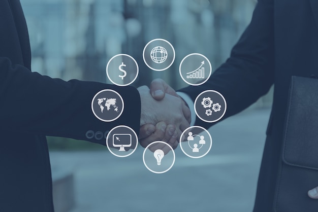 Photo sealing a deal. close-up of two young businessmen shaking hands while standing outdoors