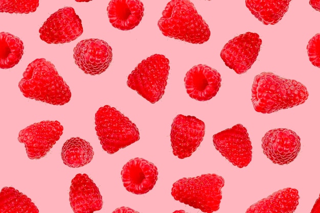 Seamless berry pattern Ripe raspberries on a pink background