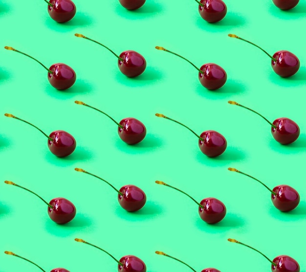 Seamless Cherry pattern on a green background 