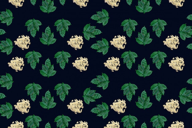 Seamless green leaves pattern on black background 