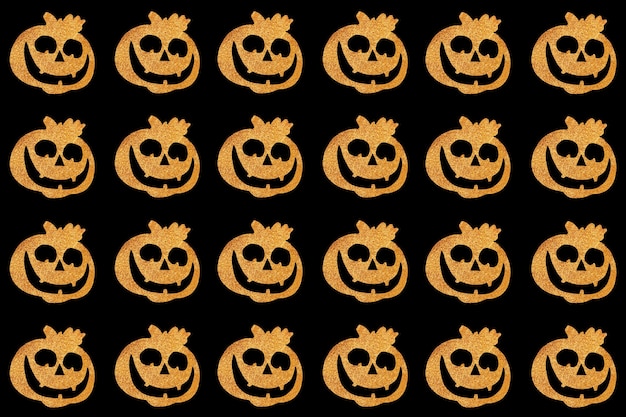 Photo seamless halloween pattern. pumpkin face on a black background. top view