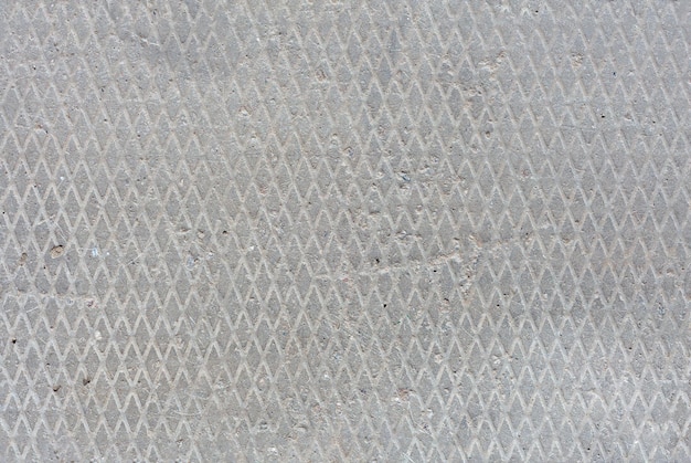 Seamless old flat concrete texture with diamond pattern and signs of light erosion