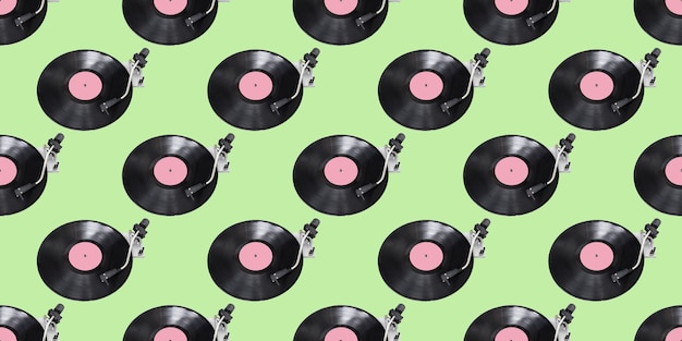 Seamless pattern. Abstract record player part isolated on green background. Disk Jockey turntable and vinyl. Retro music concept.