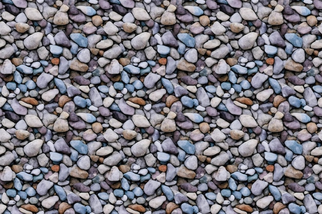 A seamless pattern of different colored pebbles.