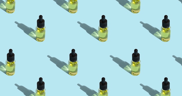 Photo seamless pattern of glass bottles with cosmetic oil