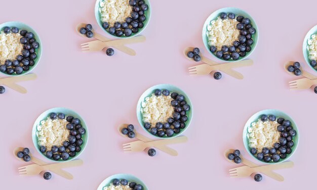 Seamless pattern Healthy breakfast Cottage cheese with blueberries in a plate on a pink background