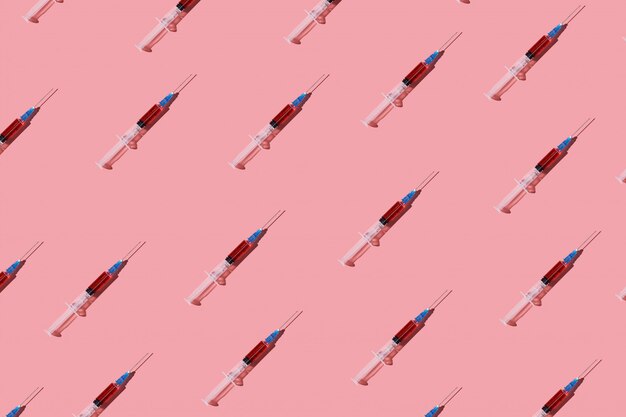 Seamless pattern of many syringes with red vaccine