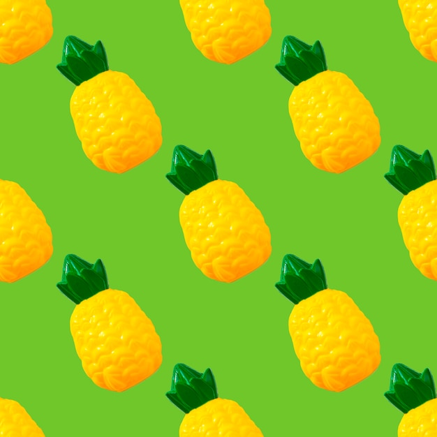 Seamless pattern Pineapple. Toy plastic fruit isolated on green background. Plastic fruit for game