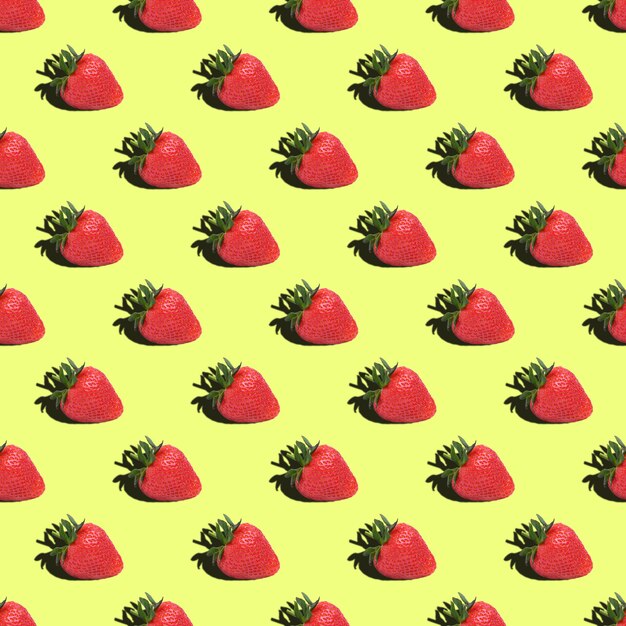 Seamless pattern of strawberries on a yellow