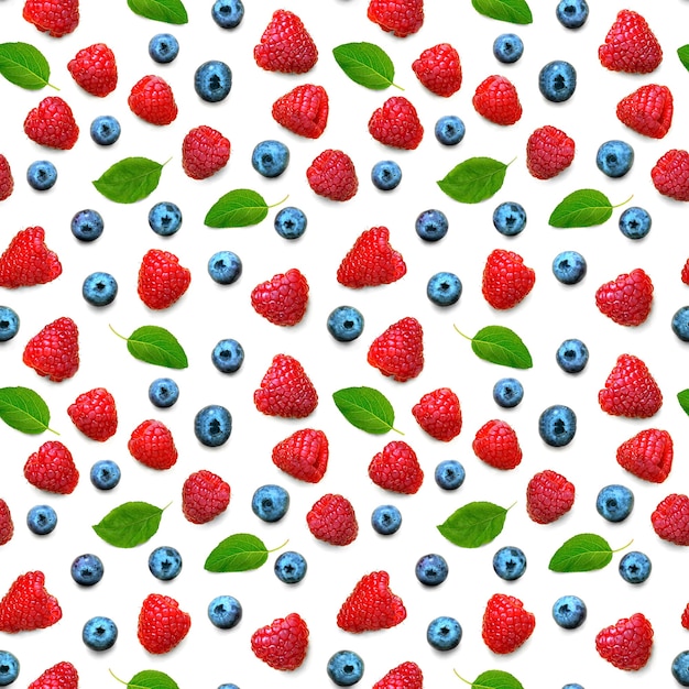 Seamless pattern of wild berries. Raspberries and blueberries with green leaves isolated on white background. Flat lay. Top view