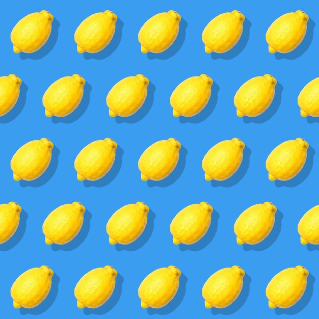 Seamless pattern with yellow lemon on blue