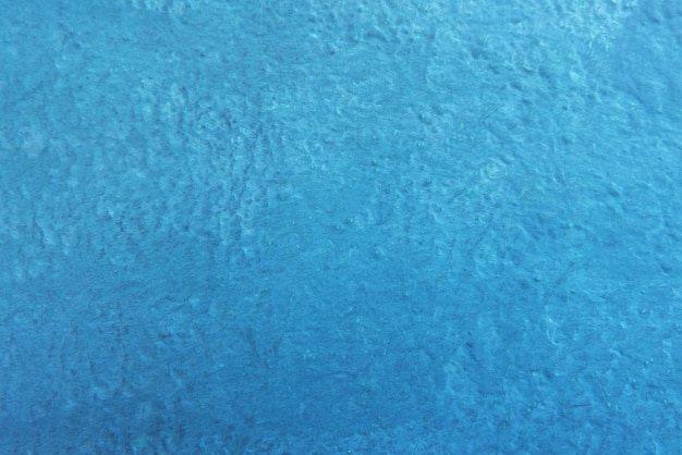塗られたダークブルーのセメントの古い壁のシームレスなテクスチャ背景x9のテキスト用のスペースを持つ粗い表面