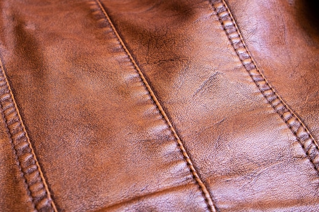 Seams on a brown leather product close up