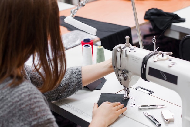 Seamstress sewing at machine