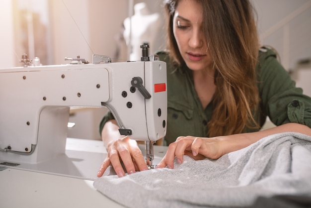 Seamstress works to new clothes ordered by internet client