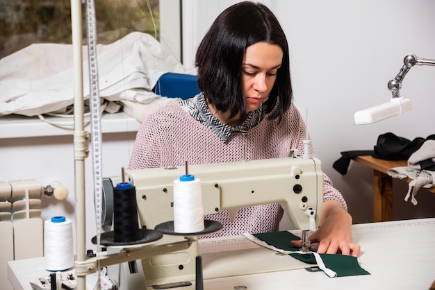 Seamstress works in the tailoring workshop