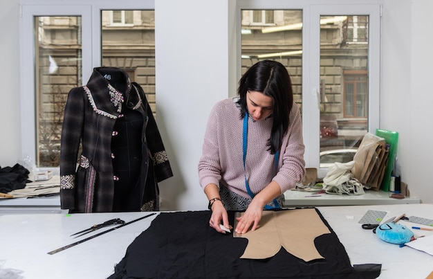 Seamstress works in the tailoring workshop