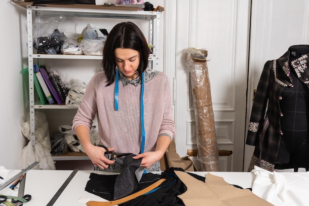 Seamstress works in the tailoring workshop